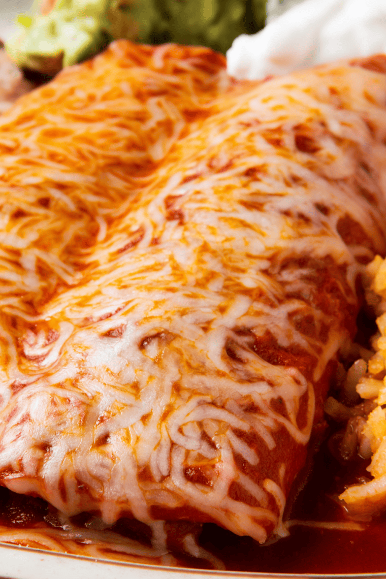 Cheesy baked chicken enchiladas with golden melted cheese on top