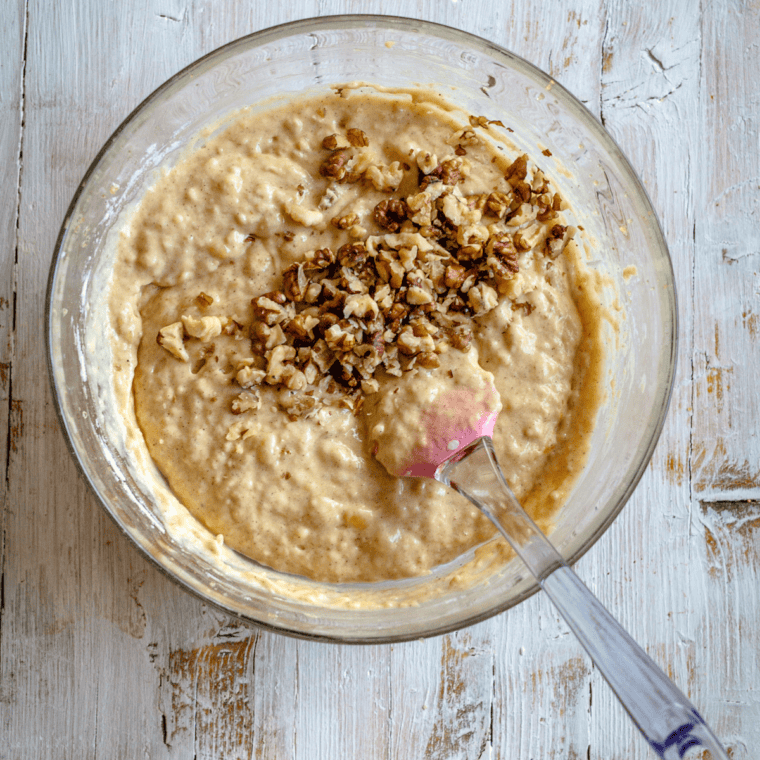 Bundt pan filled with banana pecan batter placed on trivet inside Instant Pot with water for pressure cooking at high setting