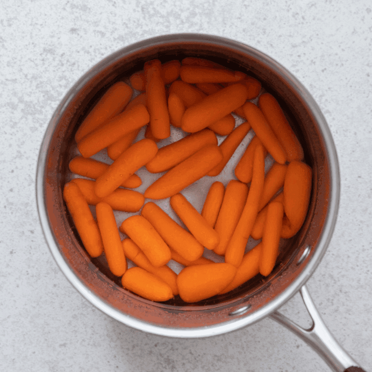 Carrots sautéing in butter until tender and fragrant