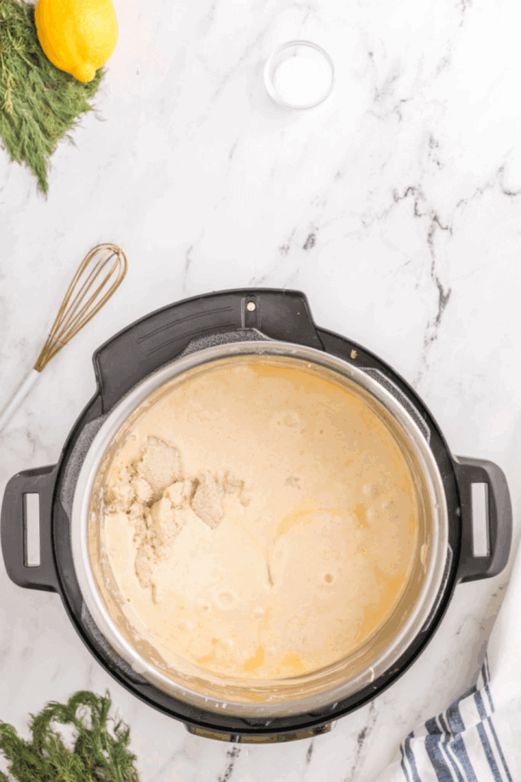 Simmering crab soup in Instant Pot with crabmeat added, stirring to combine