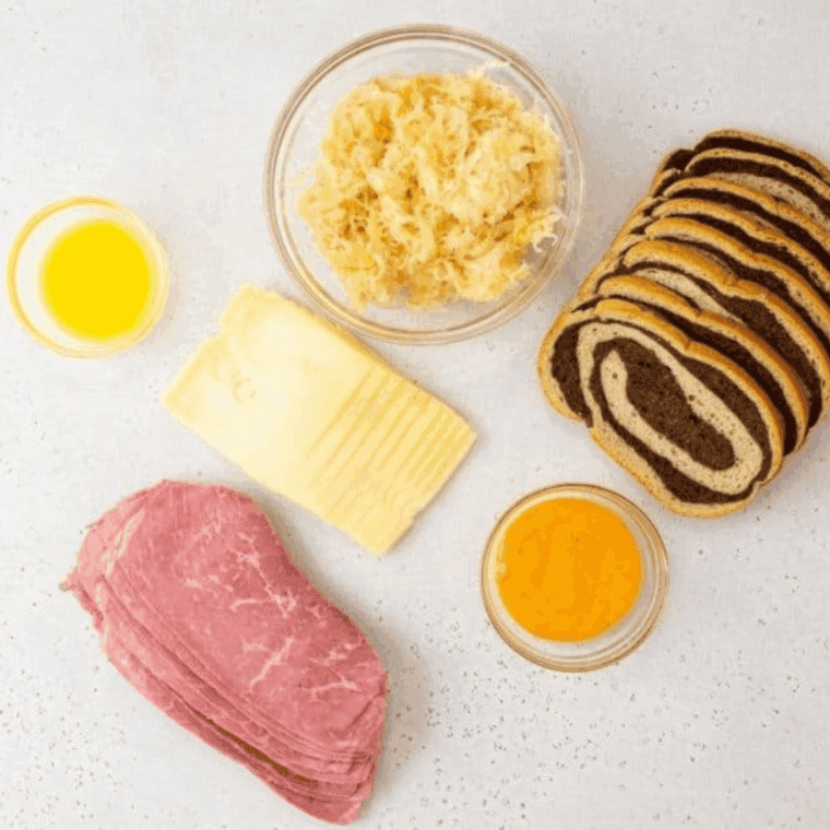 Ingredients needed for Extra Crispy Air Fryer Reuben Sandwich (Better Than a Deli!) on kitchen table.