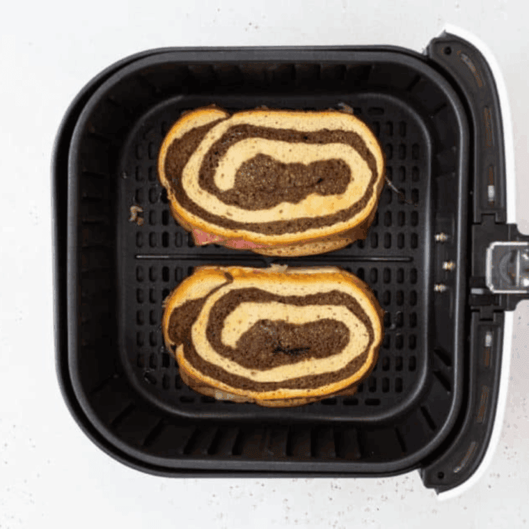 Cooking Reuben sandwiches in air fryer until golden brown and melted.