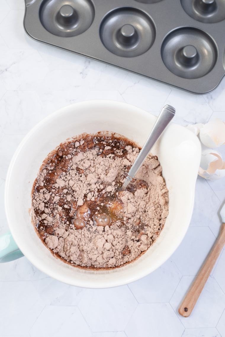 Greasing and flouring Bundt pan thoroughly to prevent cake from sticking during cooking