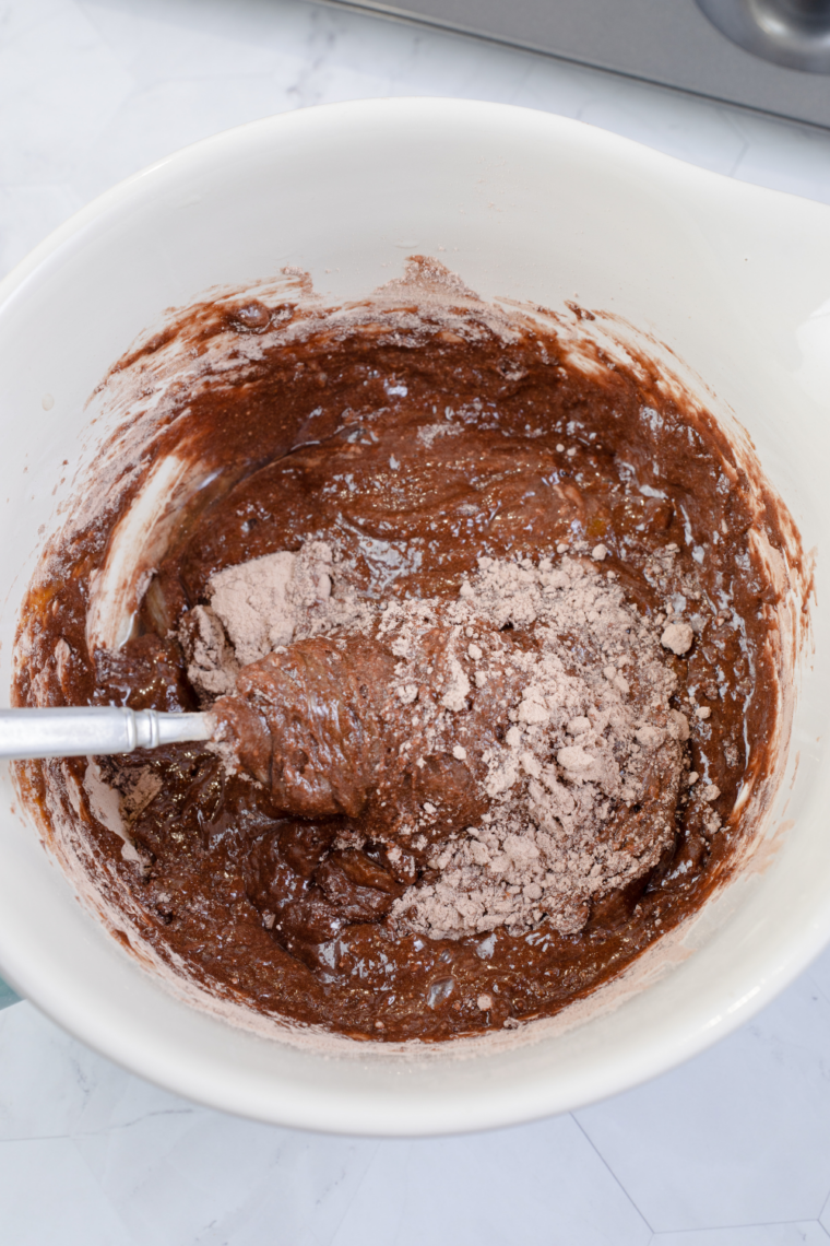 Pouring cake batter into prepared pan filling two thirds full to allow room for rising