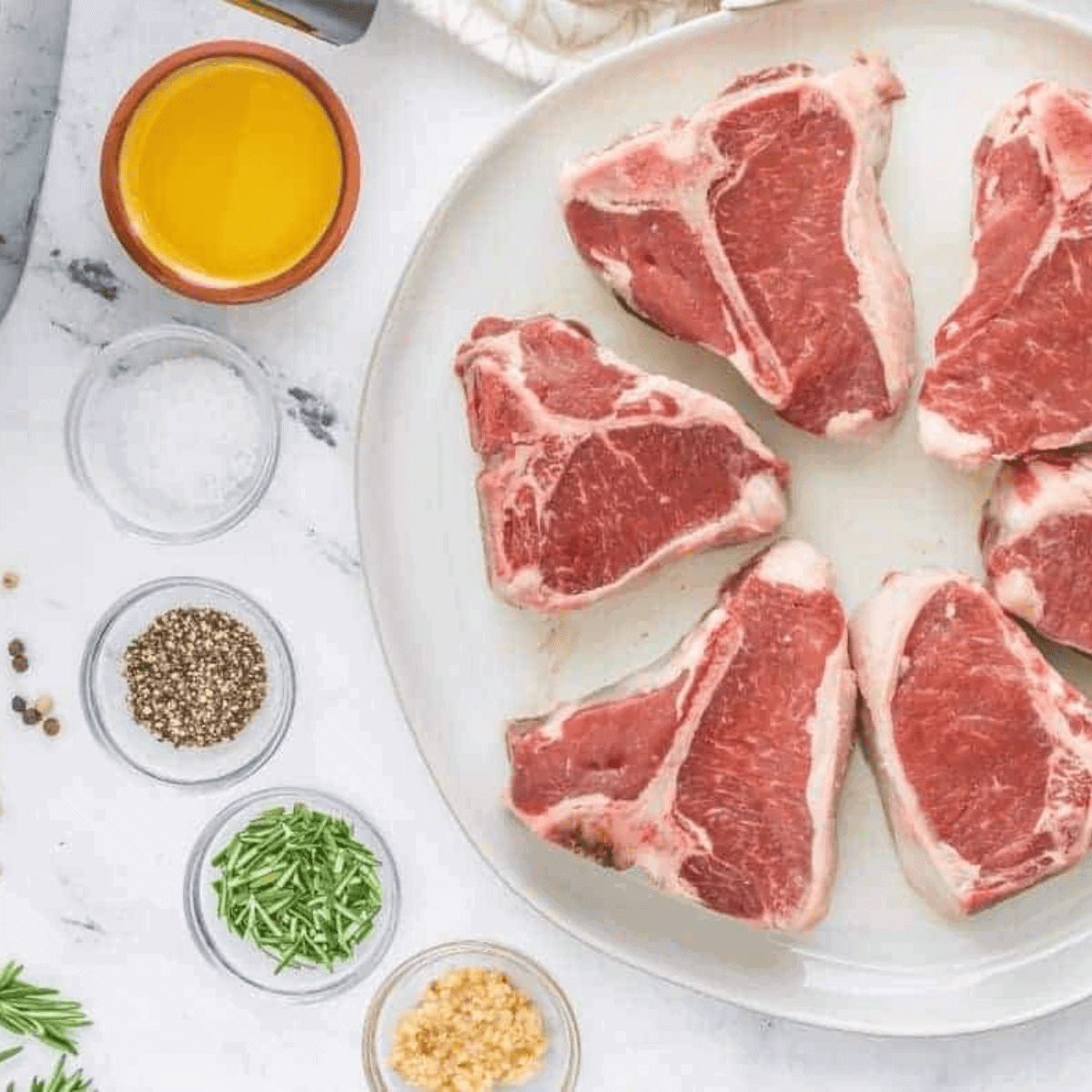 Ingredients needed for Air Fryer Rosemary Garlic Lamb Chops on kitchen table.