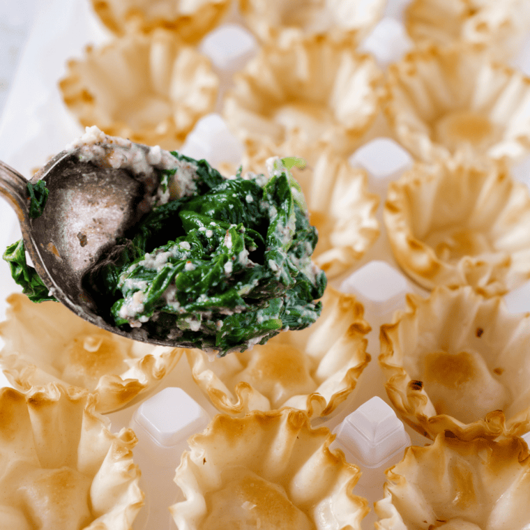 Mixing bowl filled with cheeses, egg white, herbs, and spices.