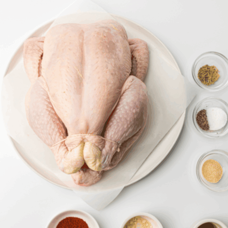 Ingredients needed for Easy Amish Whole Chicken Recipe on kitchen table.