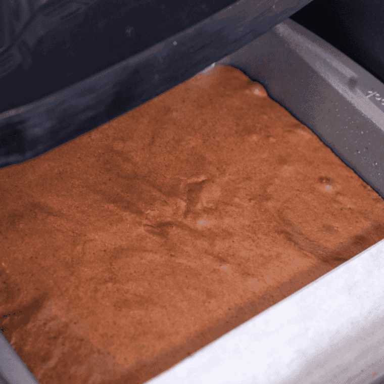 Pan of brownie batter placed inside the air fryer basket to bake