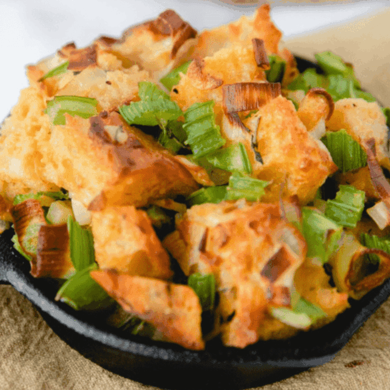 golden brown air fryer cornbread dressing in a baking dish ready to serve