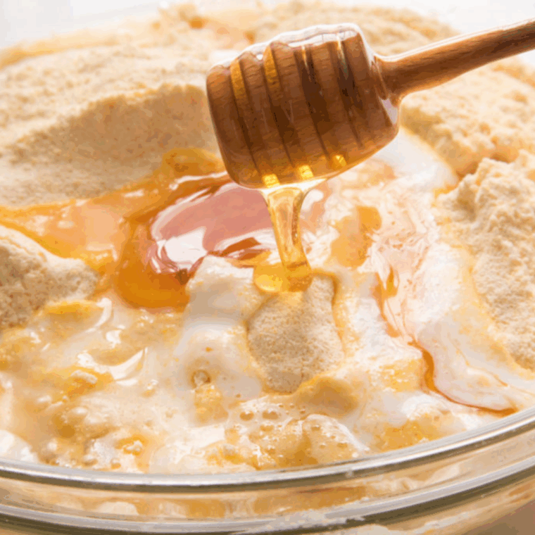 Wet ingredients and dry ingredients mixed together to form corn muffin batter