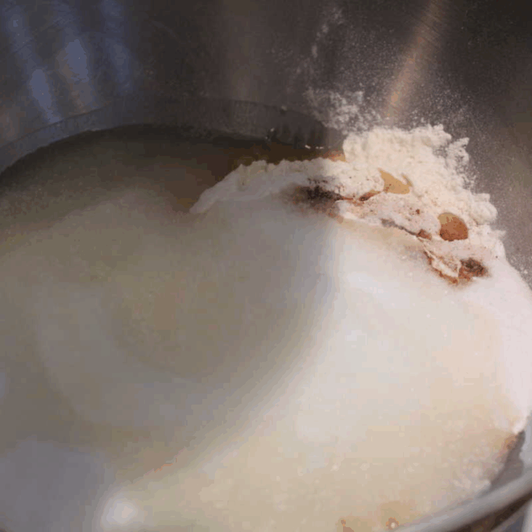 Mixing flour, sugars, baking soda, spices, and salt in a bowl