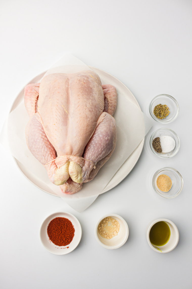 Ingredients needed for Air Fryer Whole Chicken (Crispy Skin, Juicy Meat Every Time) on kitchen table.
