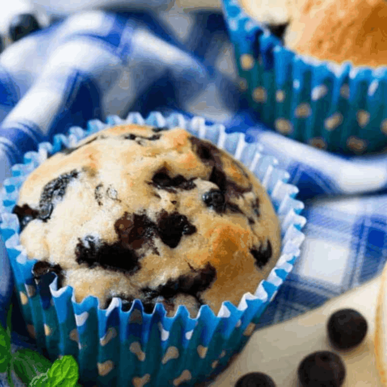 Golden air fryer blueberry lemon muffins, fluffy inside with fresh blueberries and a hint of lemon zest, ready to enjoy.