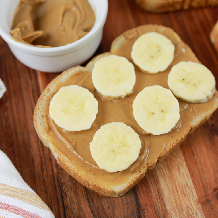Finished peanut butter banana toast plated and served warm with melted toppings