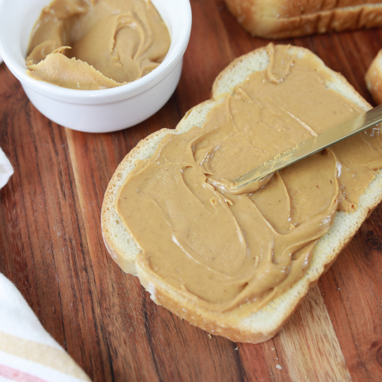 Warm toast spread with creamy peanut butter and topped with banana slices and honey