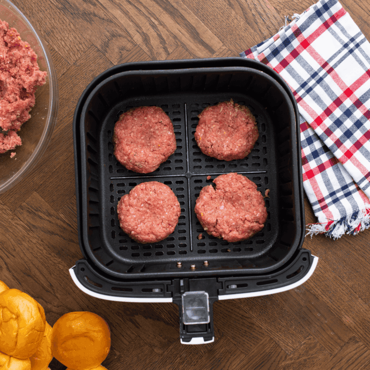 Forming slider-sized burger patties from ground beef mixture, slightly larger than buns.
