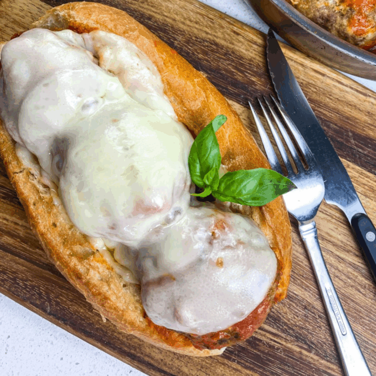Easy homemade copycat Firehouse Subs Meatball Sub on a toasted white hoagie roll, topped with melted provolone cheese and red marinara sauce.