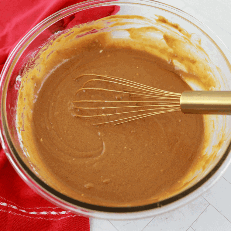 Adding brown sugar, eggs, molasses, and milk to gingerbread batter