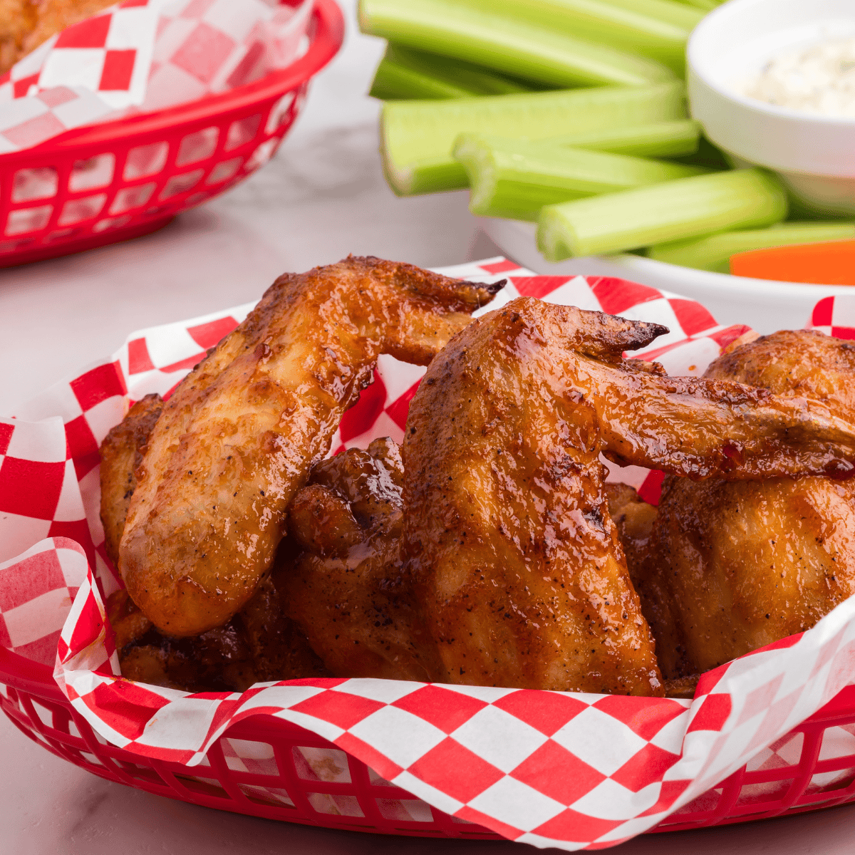 Air fryer basket filled with golden brown chicken wings cooking to crispy perfection.