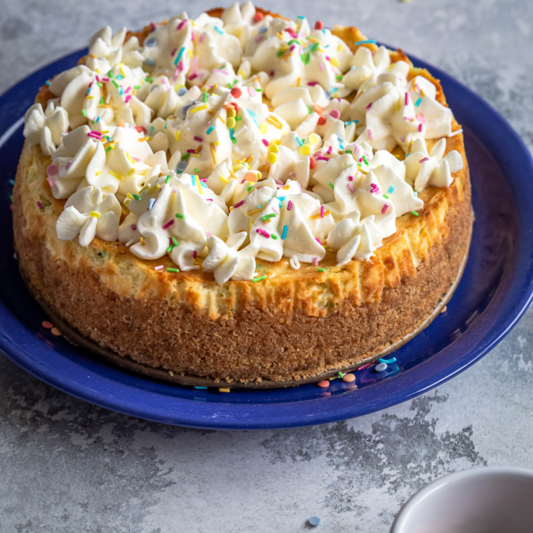 Whole Pappadeaux-style vanilla cheesecake with a smooth, crack-free top
