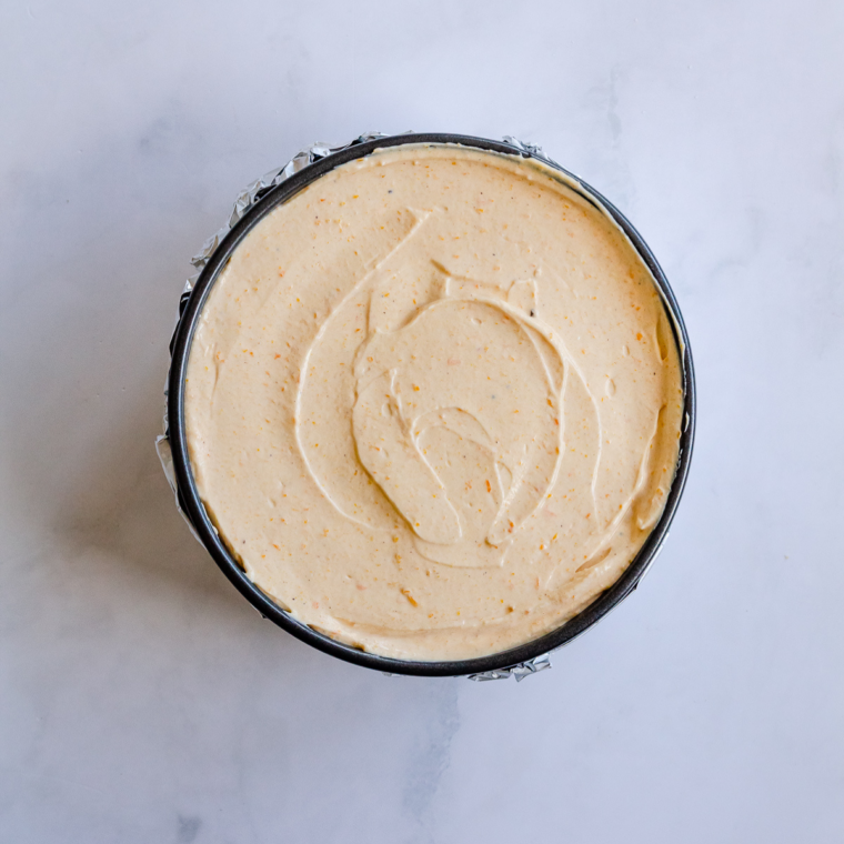 Baked vanilla cheesecake with a slightly jiggly center cooling in the oven