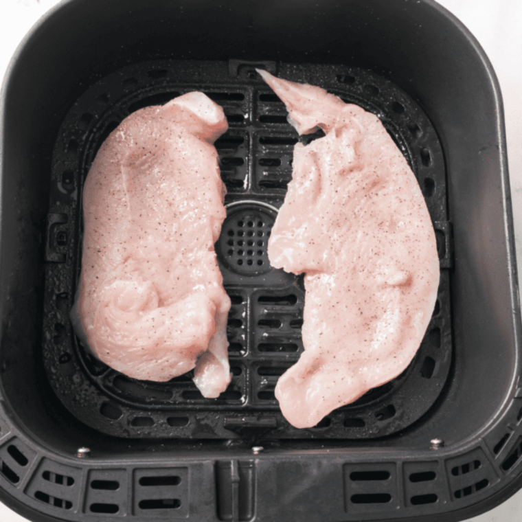 Placing turkey cutlets in air fryer basket in single layer without overlap