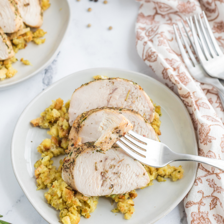 Juicy air fryer turkey cutlets sliced on plate with golden crispy edges and fresh herbs served ready to eat