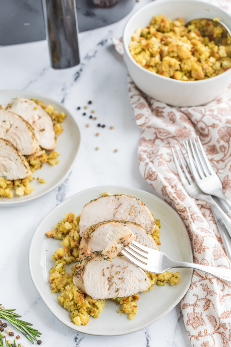 Juicy air fryer turkey cutlets sliced on a plate with golden crisp edges and herbs garnish served ready to eat