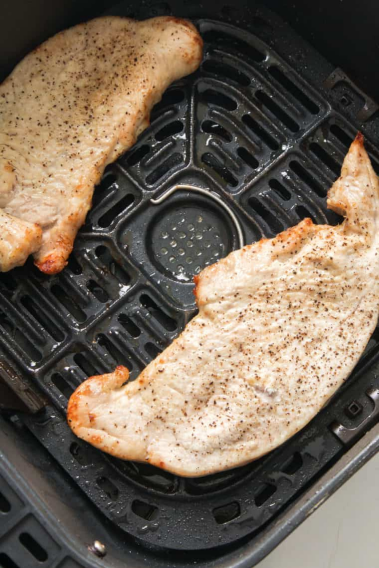 Checking internal temperature of cooked turkey cutlets with meat thermometer