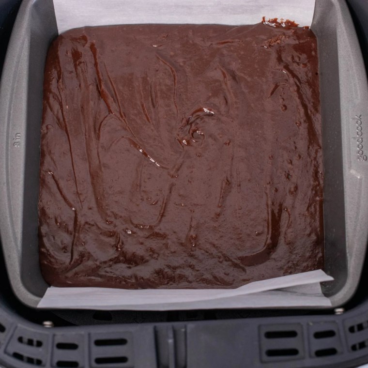 Copycat Starbucks double chocolate brownies baking in an air fryer basket