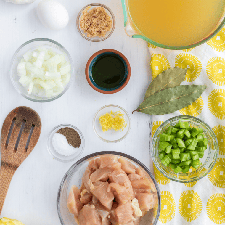 Ingredients for Instant Pot Greek lemon chicken soup: chicken, rice, eggs, lemons, onion, celery, garlic, broth, and seasonings