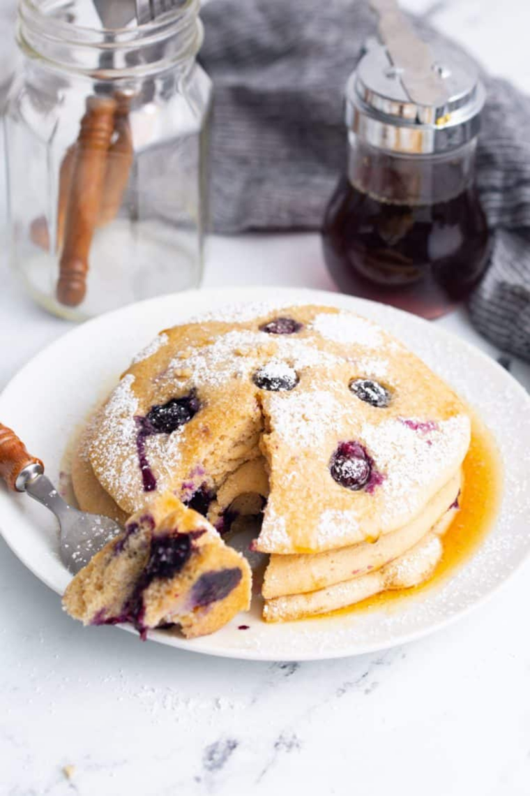 Blueberry pancakes cooking in air fryer basket until golden brown and fluffy