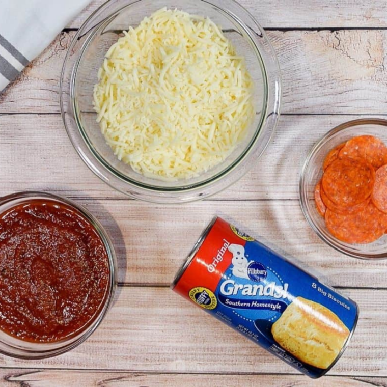 Ingredients needed for Air Fryer Bubble-Up Pizza Bake on kitchen table.