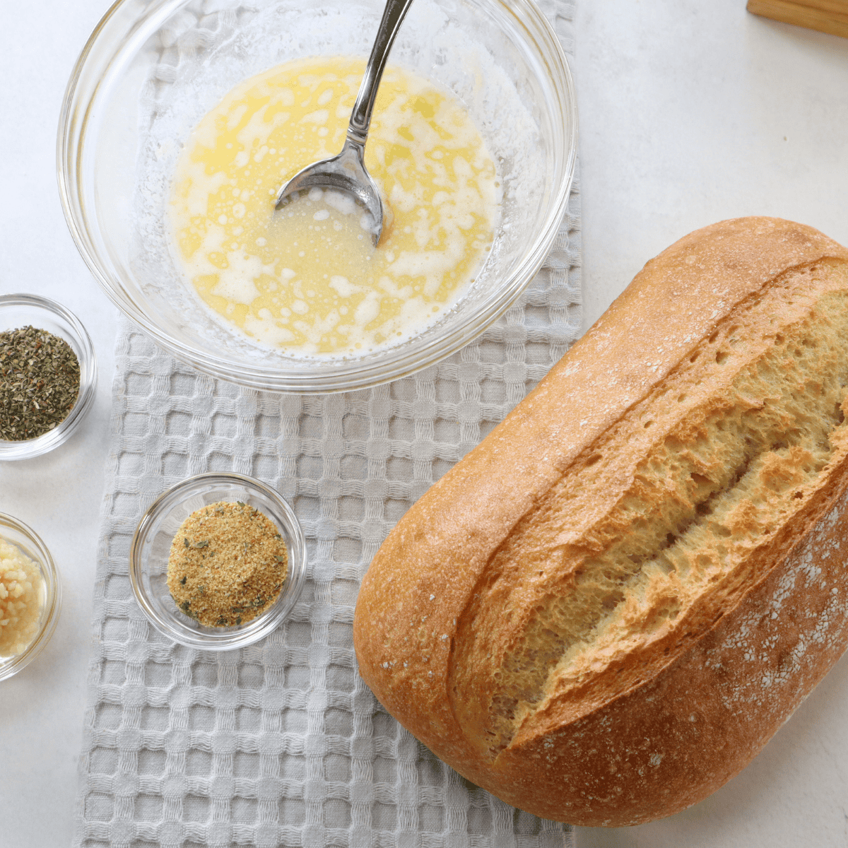 Ingredients for air fryer cheesy garlic bread rolls including sub rolls, butter, shredded mozzarella, minced garlic, and Italian seasoning