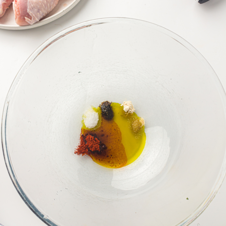 Small bowl of olive oil mixed with minced garlic, paprika, oregano, and red pepper flakes