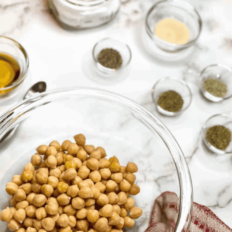 Ingredients needed for Air Fryer Garlic and Herb Roasted Chickpeas on kitchen table.