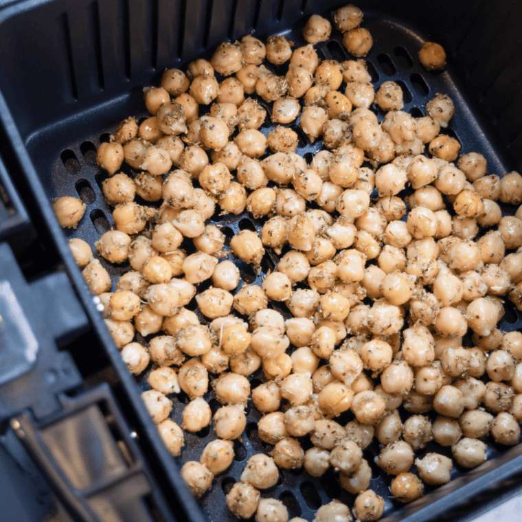 Chickpeas spread in a single layer in the air fryer basket