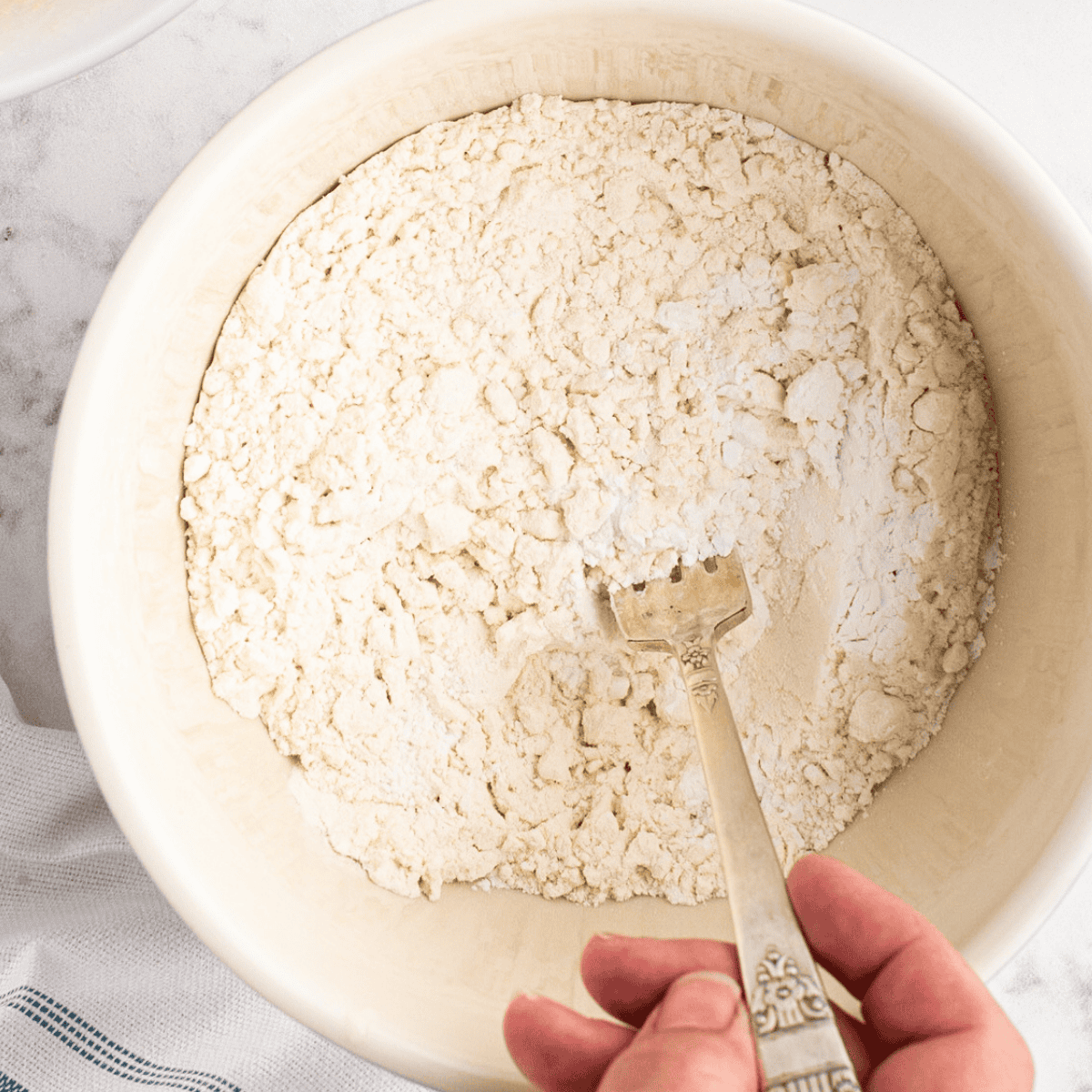 Whisking flour, baking powder, salt, and sugar together in a mixing bowl for fry bread dough