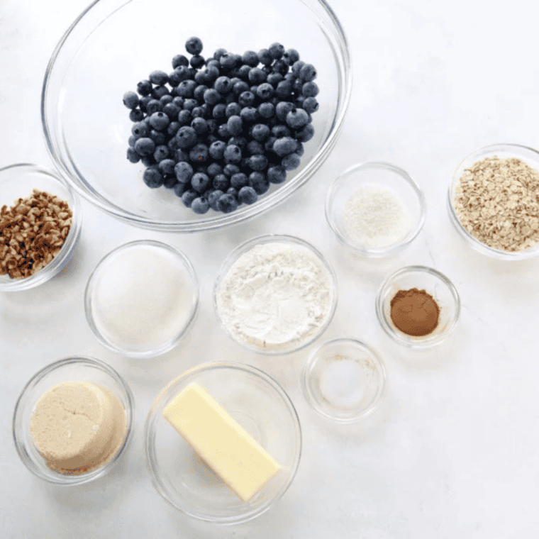 Ingredients for air fryer blueberry crisp — blueberries, oats, flour, butter, brown sugar, and cinnamon