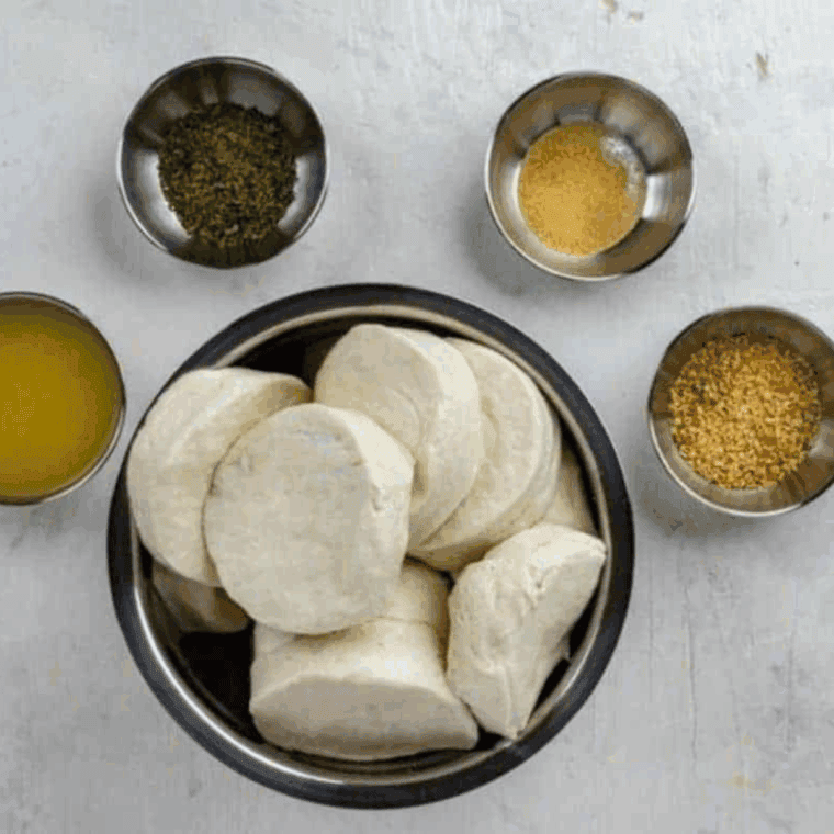 Ingredients needed for Air Fryer Parmesan and Herb Bubble Bread on kitchen table.