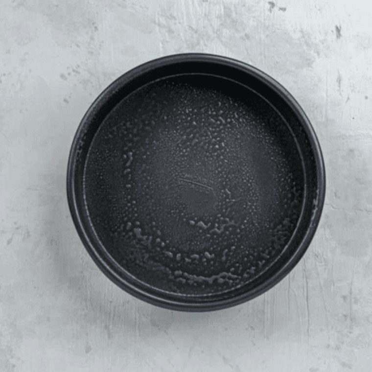 Mixing melted butter, dried parsley, garlic powder, and minced garlic for the bubble bread coating.