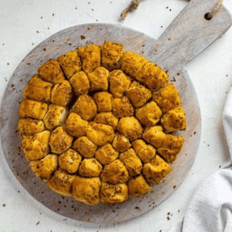 Golden brown Air Fryer Parmesan and Herb Bubble Bread in a loaf pan, showing the cheesy, pull-apart texture.