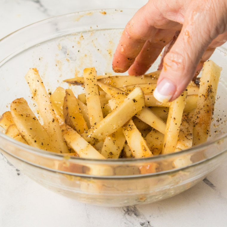 Seasoned fries baked golden and crisp on a sheet pan for copycat Chili's Texas Cheese Fries.