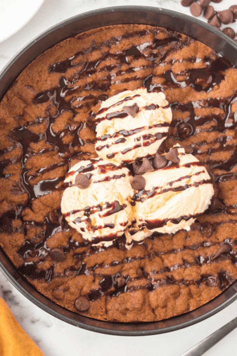 Golden, gooey chocolate chip skillet cookie fresh from the air fryer, loaded with melted chocolate chips.