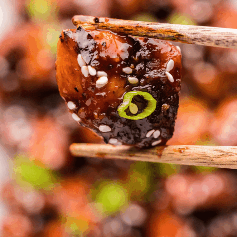 Close up on chopsticks Easy Air Fryer Firecracker Chicken.