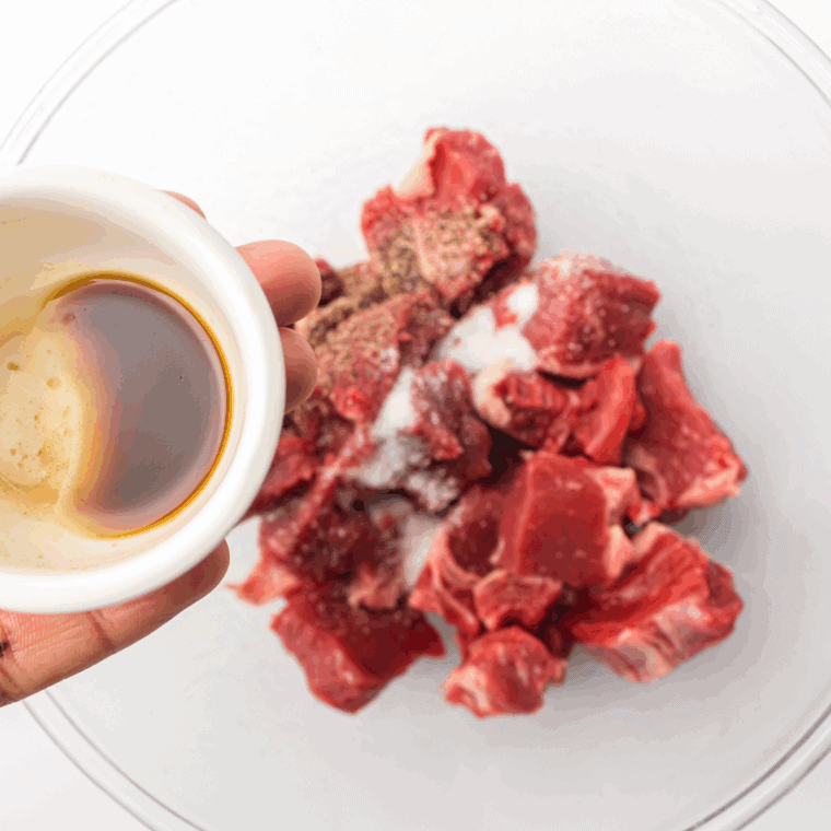 Whisking bourbon, soy sauce, brown sugar, garlic, Worcestershire, olive oil, black pepper, and onion powder in a bowl