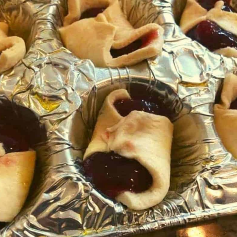 Dough corners folded over cherry filling and topped with sparkling sugar before air frying