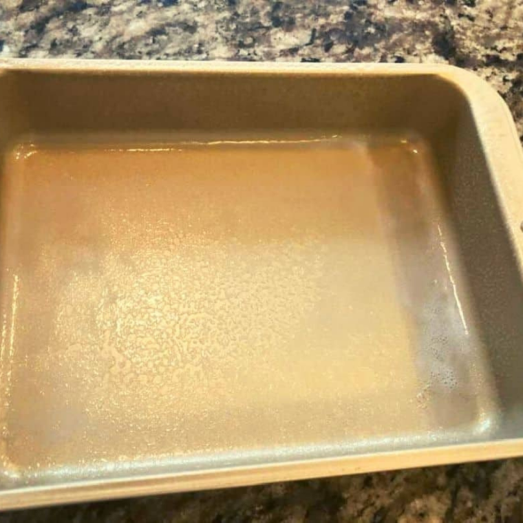 Interior of a 7-inch springform pan brushed with melted butter and dusted with cornmeal.