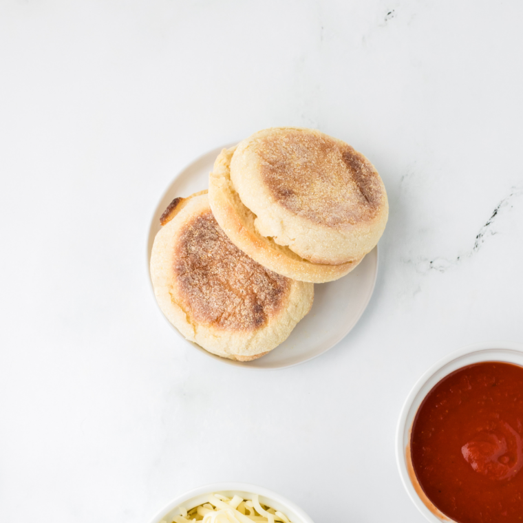 Ingredients needed for Air Fryer Peanut Butter & Jelly Streusel English Muffins on kitchen table.