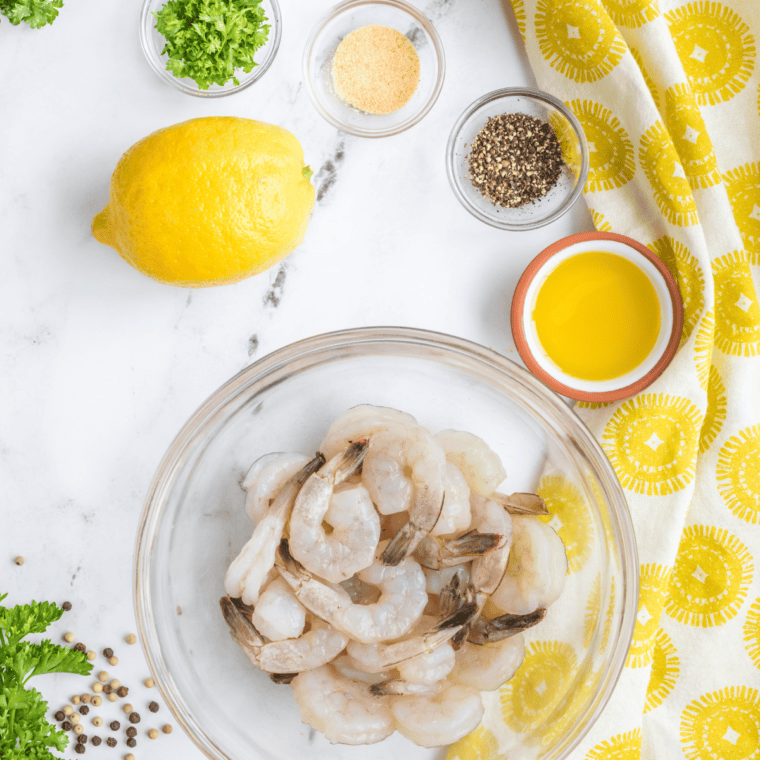 Ingredients needed for Easy Air Fryer Colossal Garlic Shrimp Recipe on kitchen table.